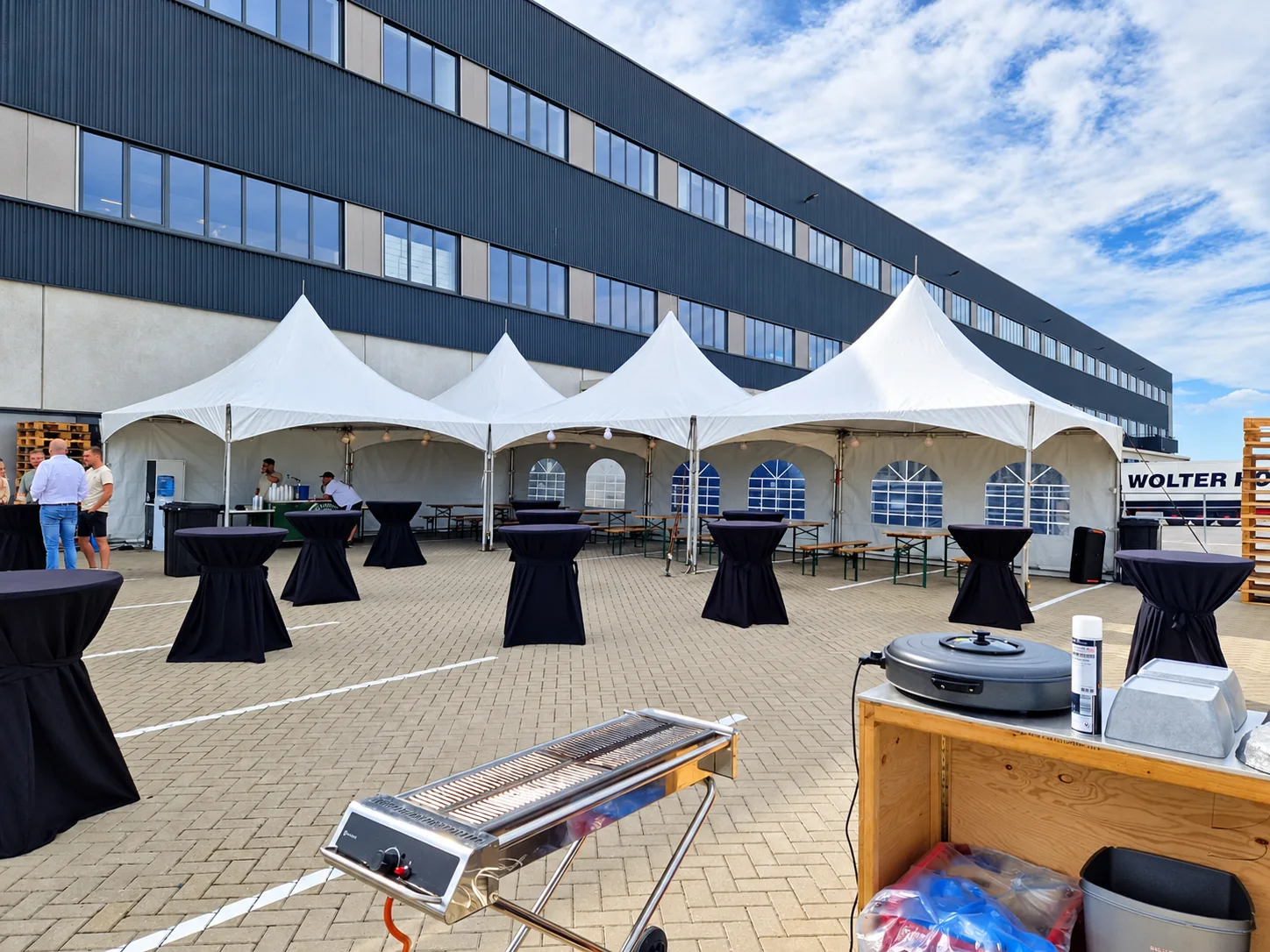 Our white pagoda tents with black cocktail tables at an event